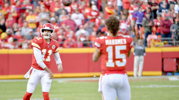 Nov 26, 2017; Kansas City, MO, USA; Kansas City Chiefs quarterback Alex Smith (11) throws passes to quarterback Patrick Mahomes (15) on the sidelines during the second half against the Buffalo Bills at Arrowhead Stadium. Mandatory Credit: Denny Medley-USA TODAY Sports